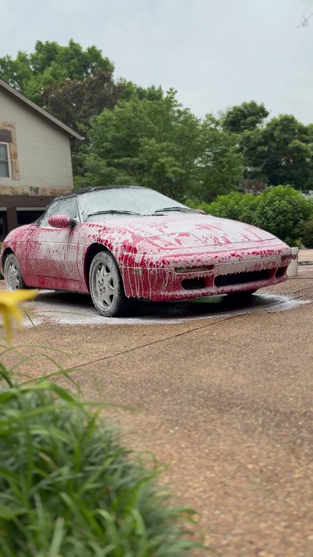 Red convertible covered in thick snow foam during a JP's Mobile Detailing wash